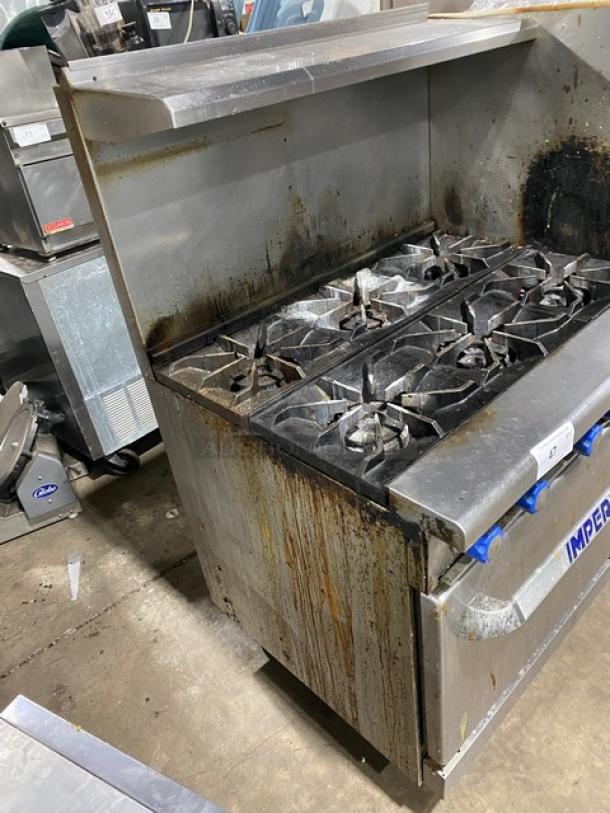 Imperial commercial natural gas 6-burner stove with overhead salamander shelf and full-size oven, stainless steel, used condition.