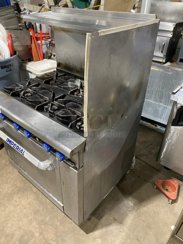 Imperial commercial 6-burner natural gas stove with overhead salamander shelf and full-size oven. All stainless steel.