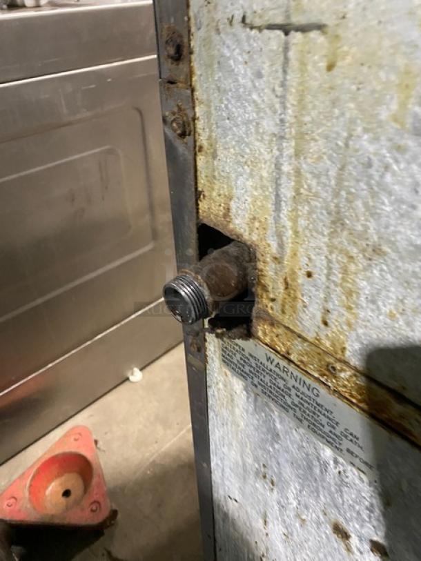 Imperial commercial gas stove, stainless steel, 6 burners, with overhead salamander shelf and full-size oven. Signs of wear.