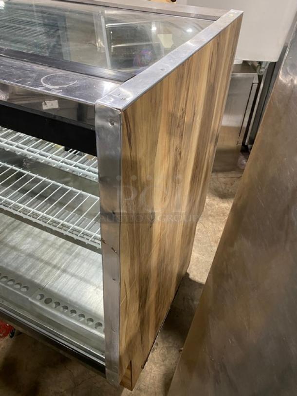 Marc SQBR59 refrigerated bakery display case with two glass sliding rear doors, poly-coated racks, and wood finish.