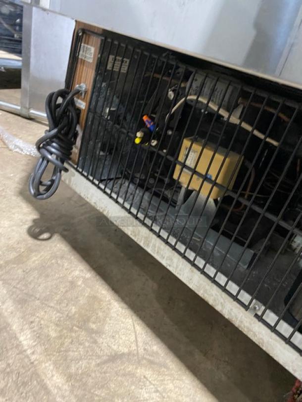 Marc SQBR59 refrigerated bakery/deli display case, 115V, showing compressor unit with coiled power cord, poly-coated racks.