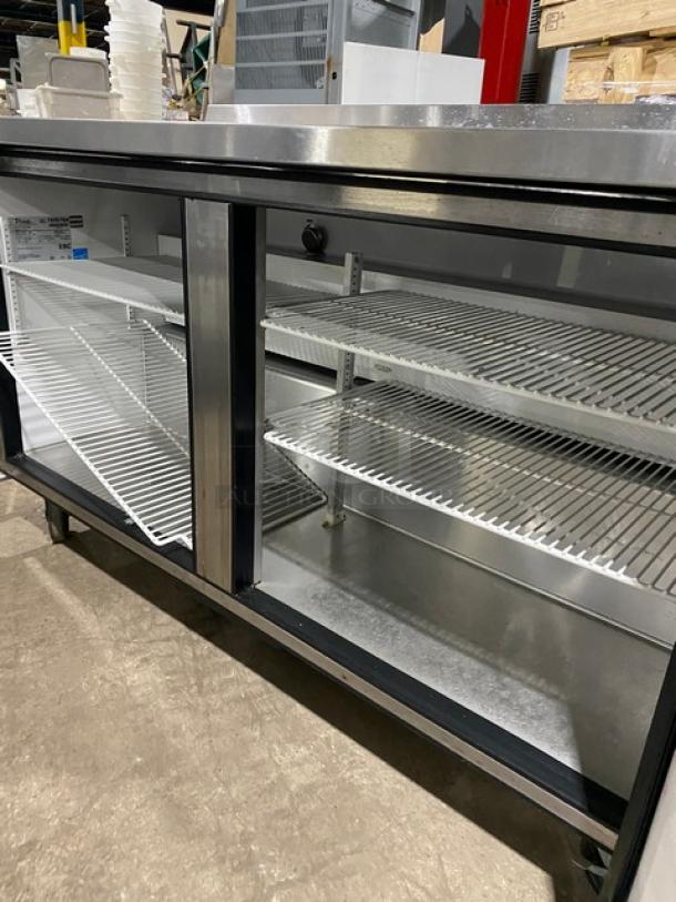 True TWT60 stainless steel refrigerated prep table with backsplash, 2-door storage, poly-coated racks, and casters, 115V 1Phase.