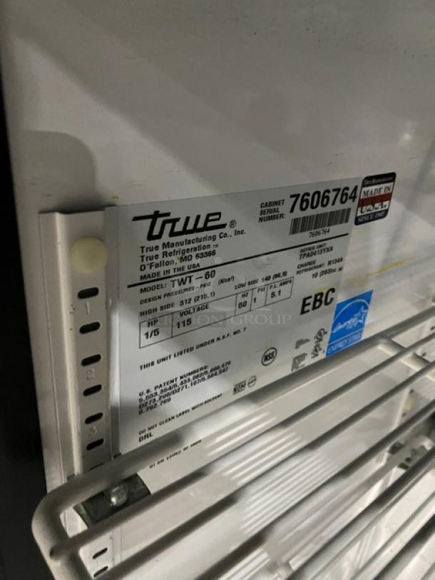 True Commercial Refrigerated Work Table, Model TWT60, Serial 7606764, stainless steel, with backsplash, poly-coated racks, on casters.