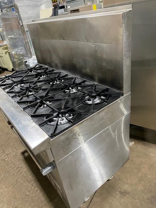 Garland H2S4 10-burner natural gas stove, stainless steel, with raised backsplash, 2 ovens, on casters, commercial grade.