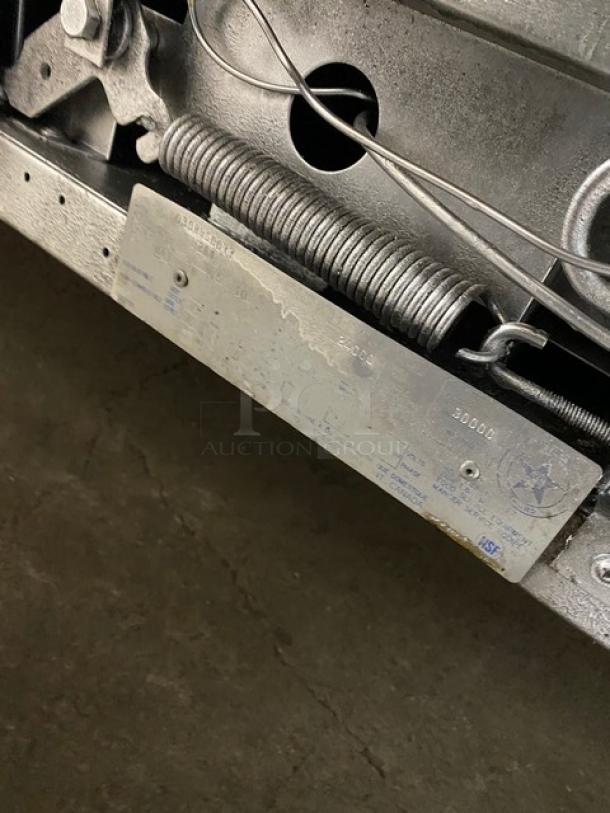 Garland model H2S4 metal tag with serial 030HHGC077, showing industrial labeling and manufacturing details.