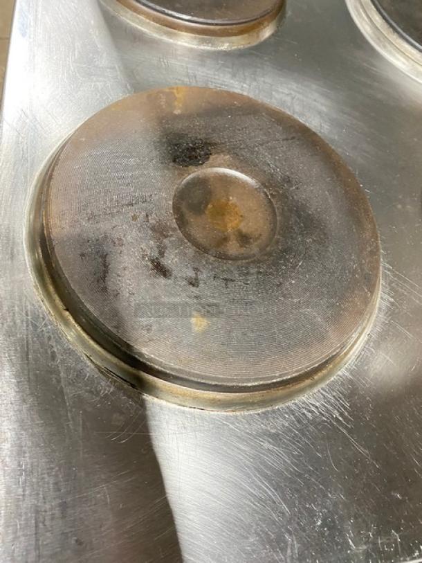 Cookline commercial stainless steel 6-burner induction range, includes oven, backsplash, and salamander shelf, 208V. Used condition.