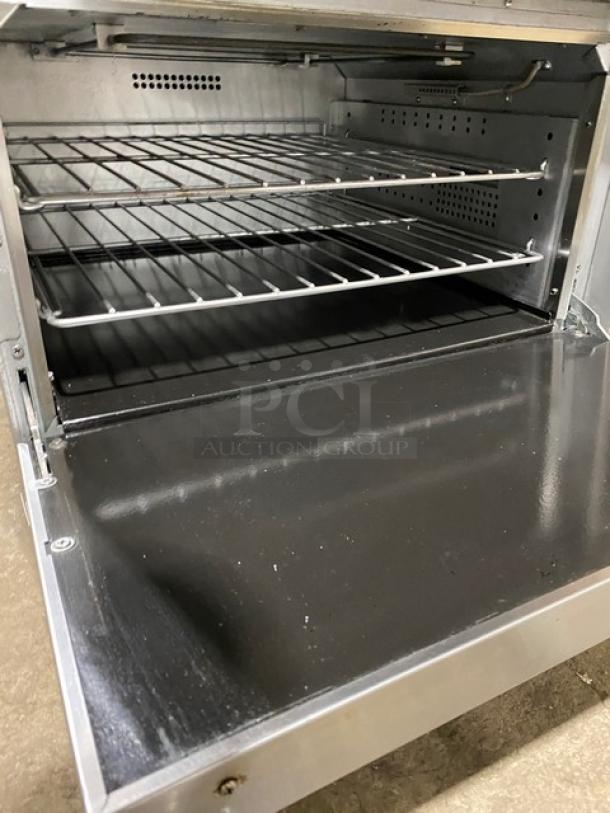 Cookline 6-burner induction range, stainless steel, with raised backsplash, oven, and salamander shelf, 208V, commercial use.