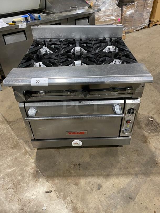 Vulcan commercial 6-burner gas stove with full-size oven, all stainless steel, on casters. Vulcan logo visible. Excellent condition.