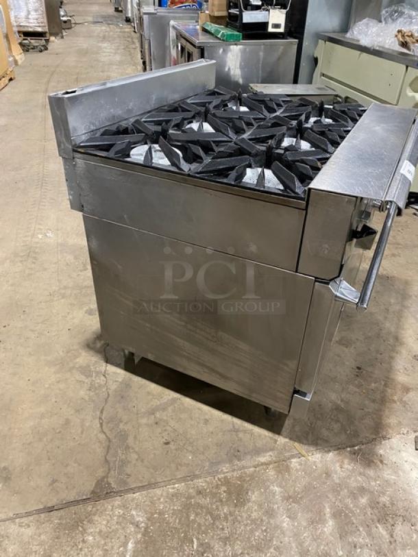 Vulcan commercial 6-burner natural gas stove with full-size oven, stainless steel, on casters, excellent condition.