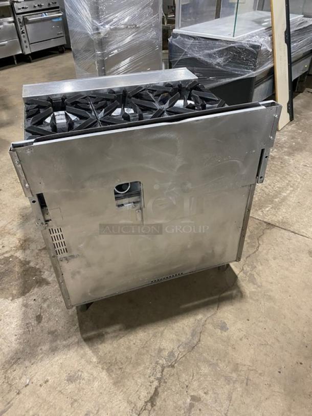 Vulcan commercial stainless steel 6-burner stove with full-size oven, natural gas powered, on casters, in good condition.