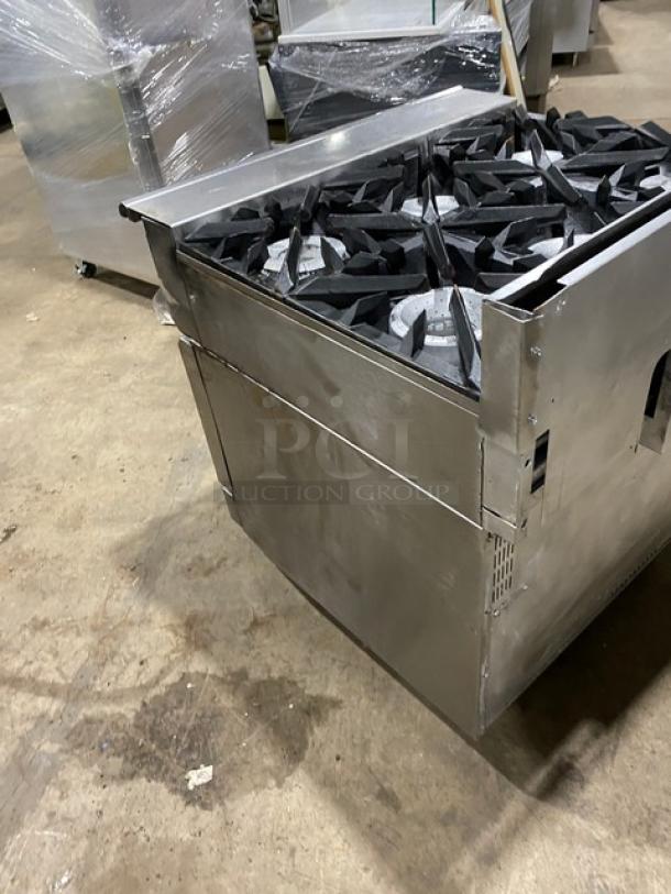 Vulcan commercial 6-burner natural gas stove with full-size oven, stainless steel, on casters, used condition.