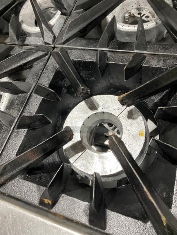 Vulcan commercial 6-burner natural gas stove, stainless steel, with full-size oven underneath, on casters. Clean burners.