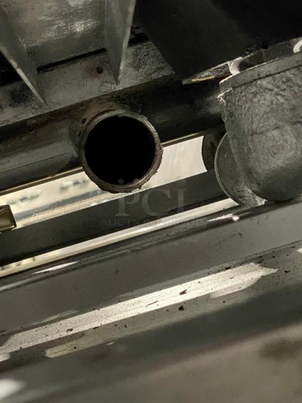 Vulcan commercial gas-powered 6 burner stove, stainless steel, visible undercarriage and casters, full-size oven.