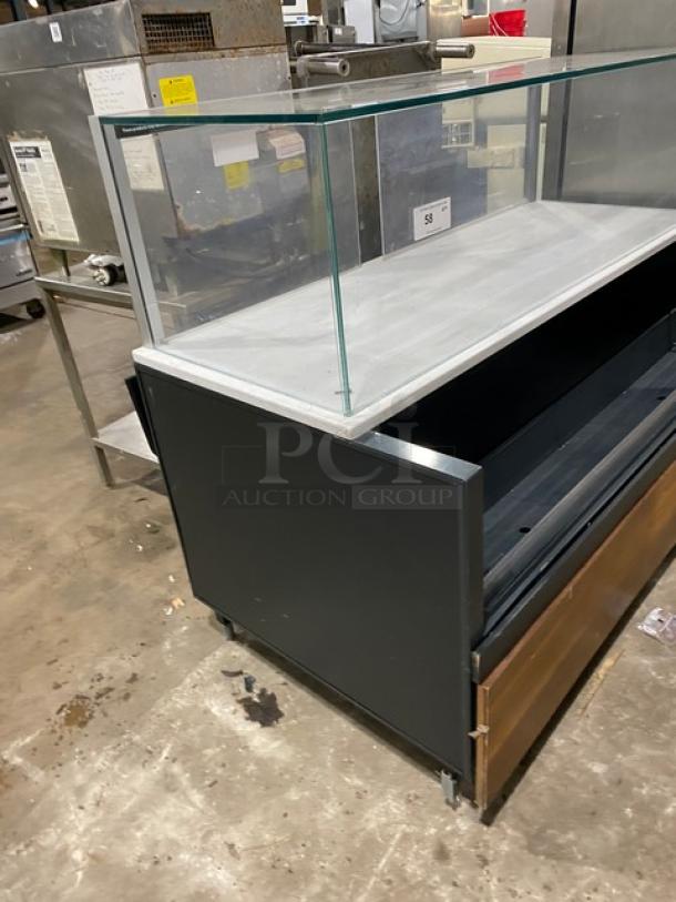 Structural Concepts multi-level refrigerated display case, upper glass showcase, rear sliding doors, with serve/prep shelf.