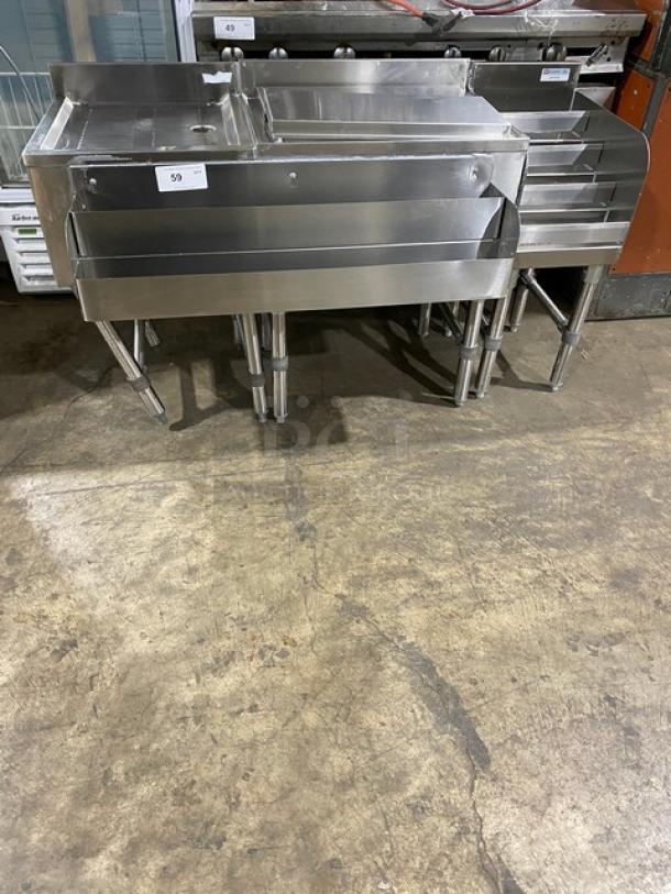 NBR Stainless Steel Under Bar Sink, Model LD1218, with left-side draining table and right-side bottle display, on legs.