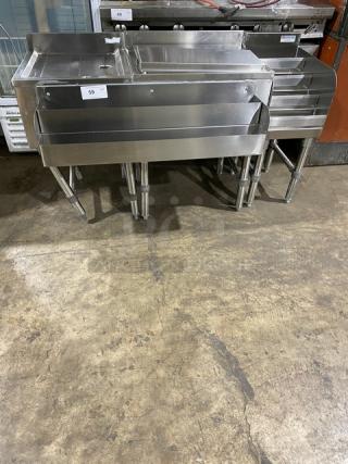NBR Stainless Steel Under Bar Sink, Model LD1218, with left-side draining table and right-side bottle display, on legs.