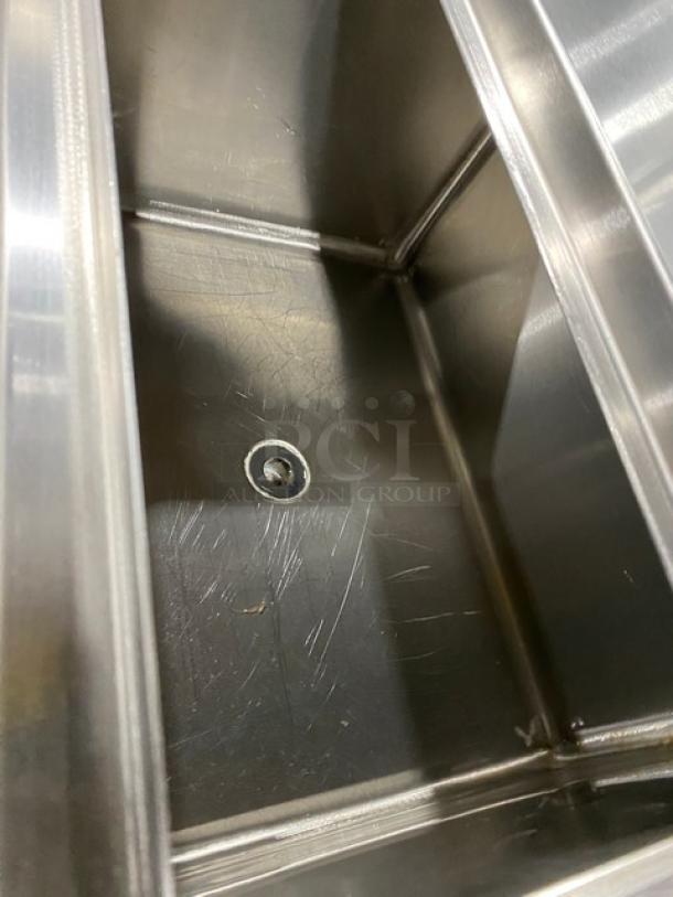 Stainless steel NBR Model LD1218 under-bar sink with left draining table and right bottle display. Good condition.