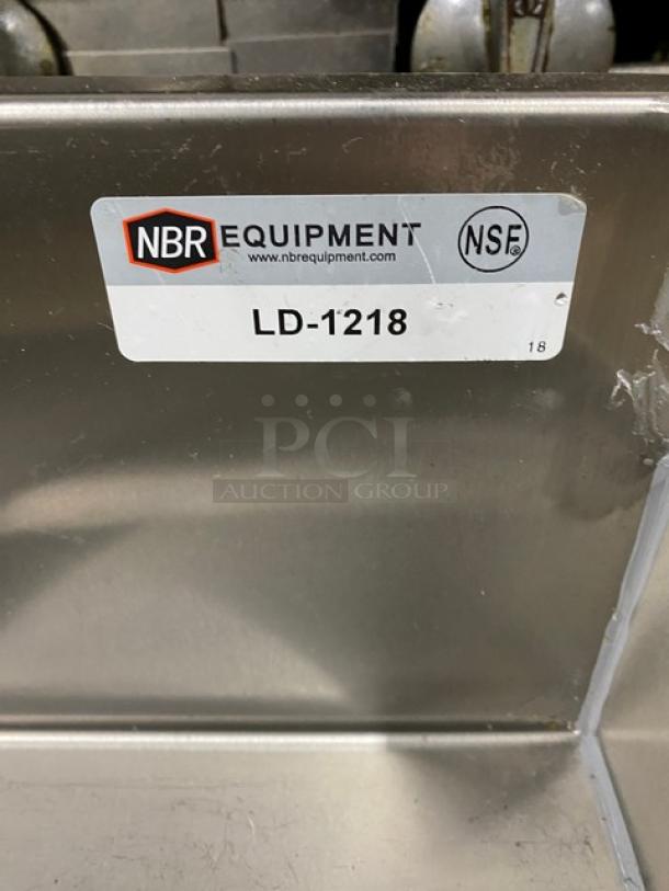 NBR LD1218 stainless steel under-bar sink; left side draining table, right side bottle display; on legs; NSF certified.