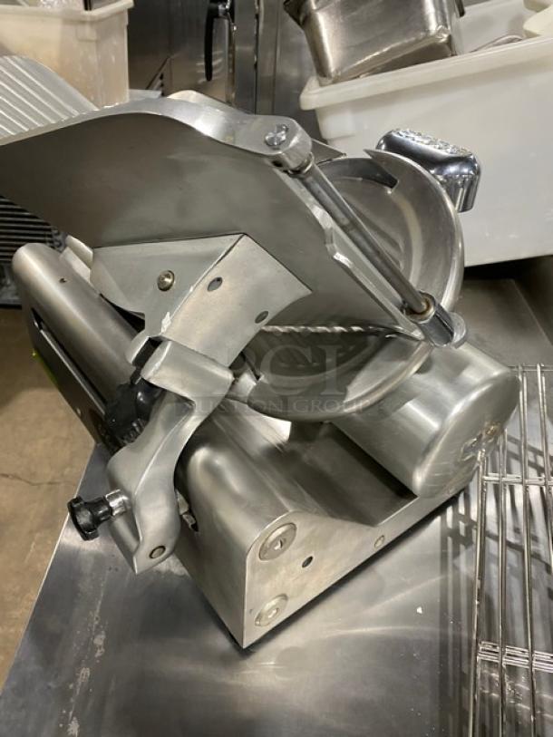 Globe Model 50 stainless steel deli meat slicer, heavy-duty, intact blade, with serial number 626679, excellent condition.