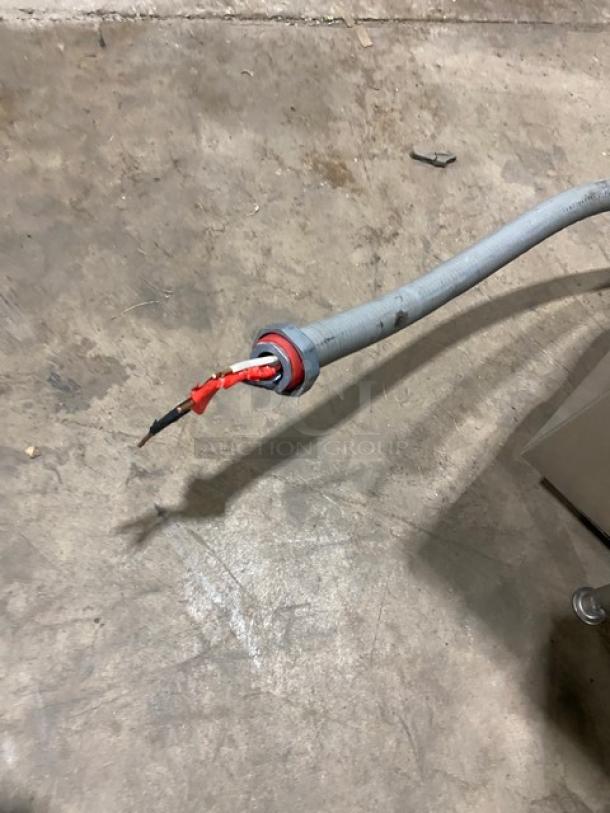 Southbend EZ3 electric steamer power cable on concrete floor, showing insulation and connectors. Appears worn.