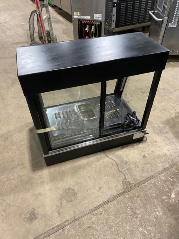 Commercial countertop warming food display case, model FW22. Glass showcase, 2 rear sliding doors. 110V, 1 Phase.