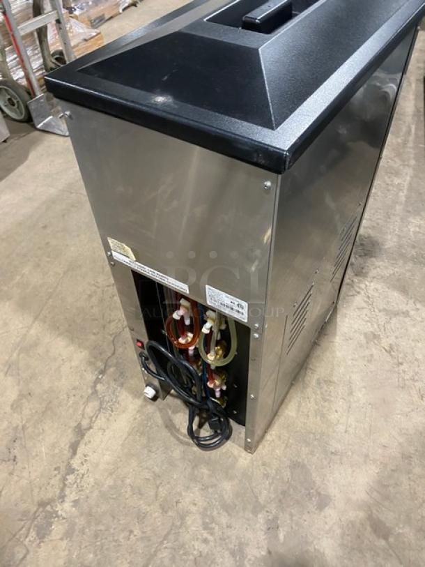 Blendtec commercial stainless steel blender with ice dispenser, digital controls, 120V. Side view showing power cords and tubing.