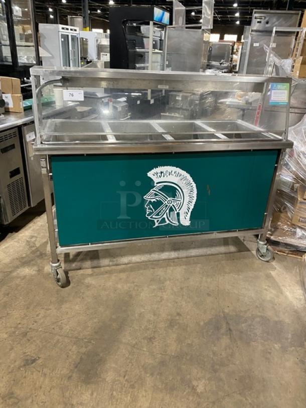 Atlas Metal VIH4 4-bay steam table with sneeze guard. Features lowering prep/serve line, 240V, and casters. Green panel design.