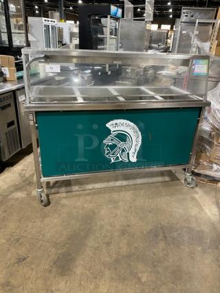 Atlas Metal VIH4 4-bay steam table with sneeze guard. Features lowering prep/serve line, 240V, and casters. Green panel design.