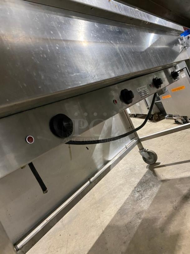 Atlas Metal VIH4 4-bay steam table with sneeze guard, lowering prep line, and casters. Features control knobs, sturdy build.