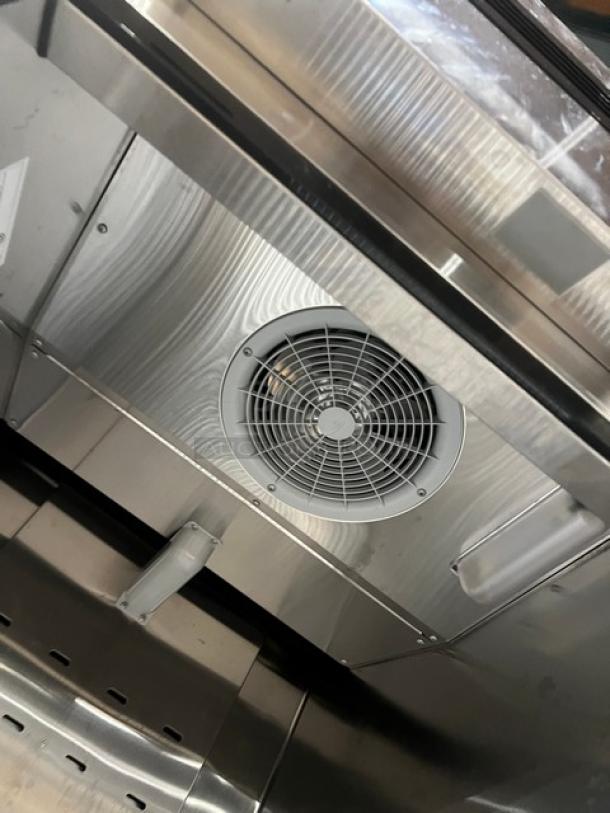 Stainless steel interior of Atosa MBF8501GR single door reach-in freezer. Includes poly-coated racks and fan vent.