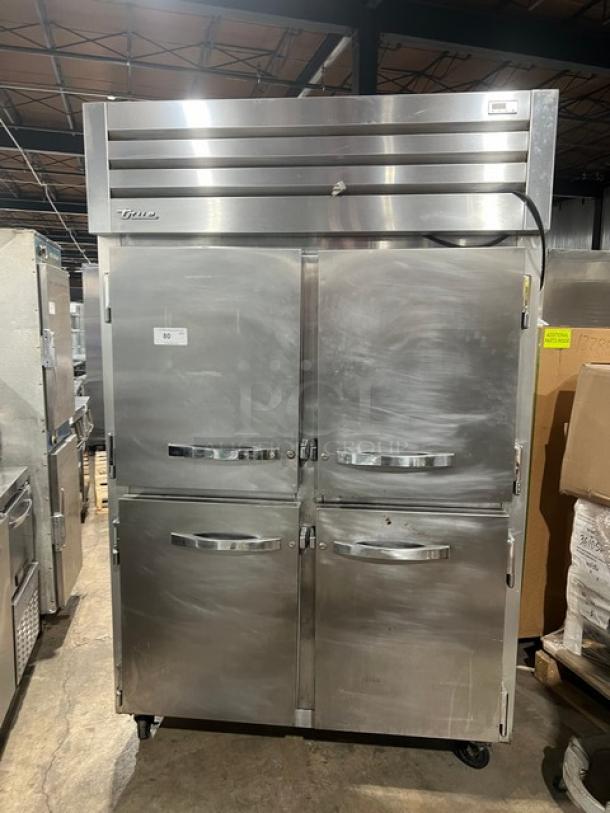 True STG2R4HS commercial refrigerator, stainless steel, 4 half doors, on casters, 115V, serial 7630823, excellent condition.
