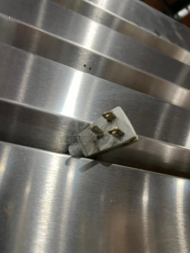 True commercial refrigerator plug on stainless steel surface, model STG2R4HS. Features 115V 1Phase connection.