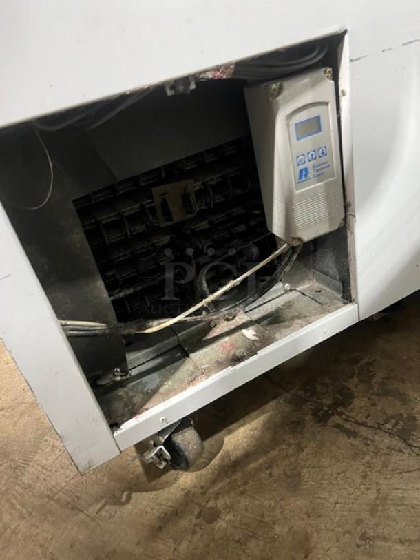 Alto Shaam Model 1200TH ice cream cabinet, shown on casters, with visible interior components and control panel, used condition.
