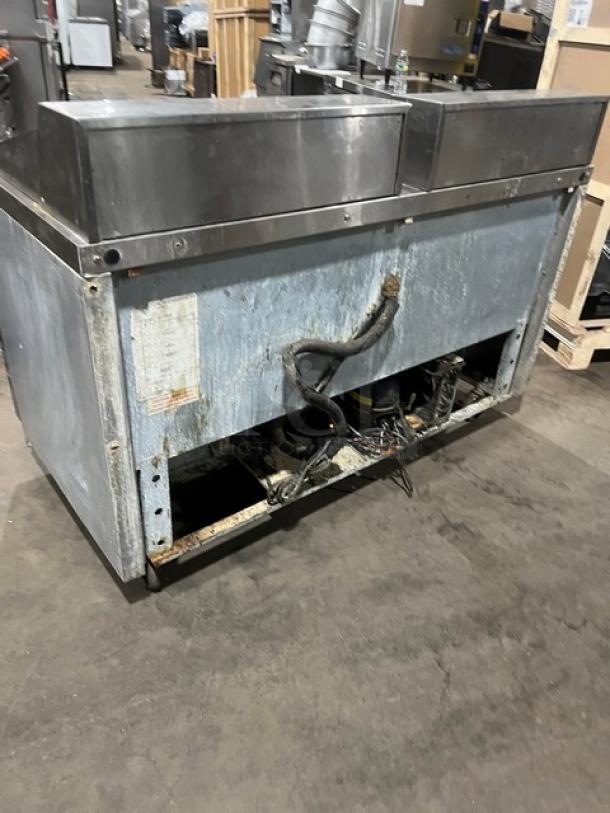 Continental SW6024M refrigerated sandwich prep table, stainless steel, 4 drawers, 115V 1Phase, on casters, visible wear.