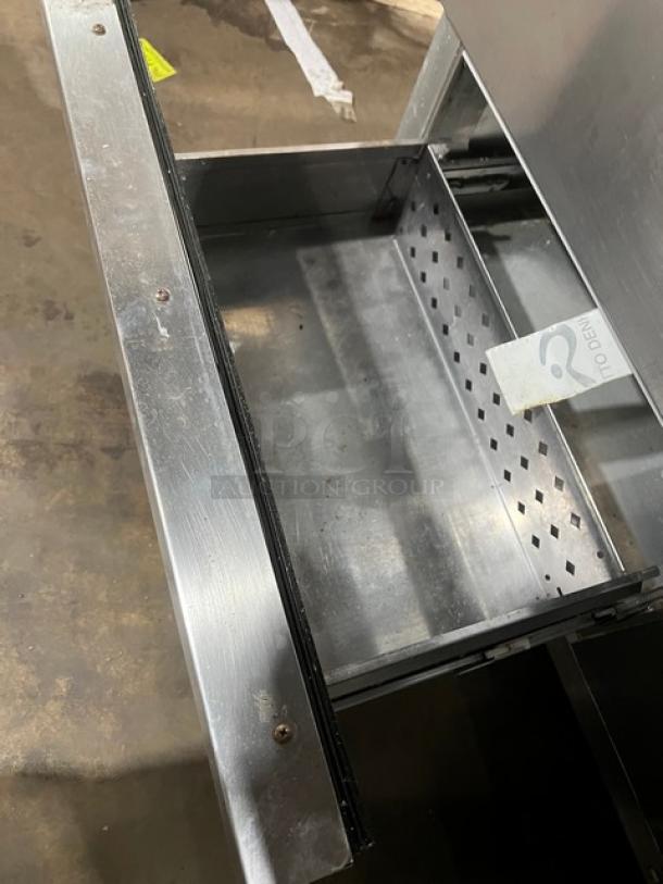 Continental SW6024M stainless steel refrigerated prep table with 4 drawers, on casters, drawer interior shown.