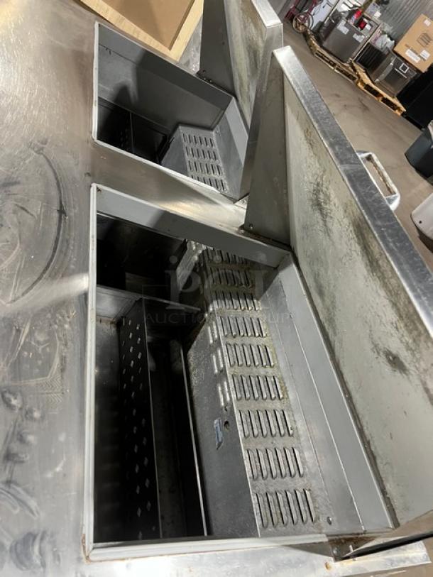 Continental SW6024M stainless steel refrigerated mega top sandwich prep table with 4 drawers and casters.