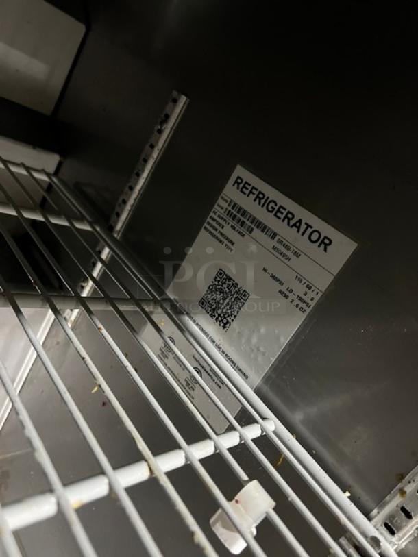 Hoshizaki SR48B18M refrigerated prep table with 2-door storage, stainless steel, poly-coated racks, model and serial label visible.