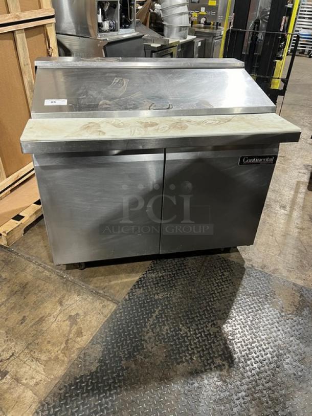 Continental refrigerated prep table, model SW4818M, with a commercial cutting board and 2-door storage. Stainless steel.