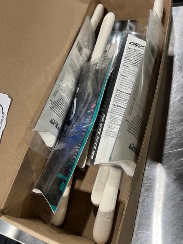 Four new Dexter Sani Safe 10" pot forks, model S203, in original packaging, indicating high quality and durability.