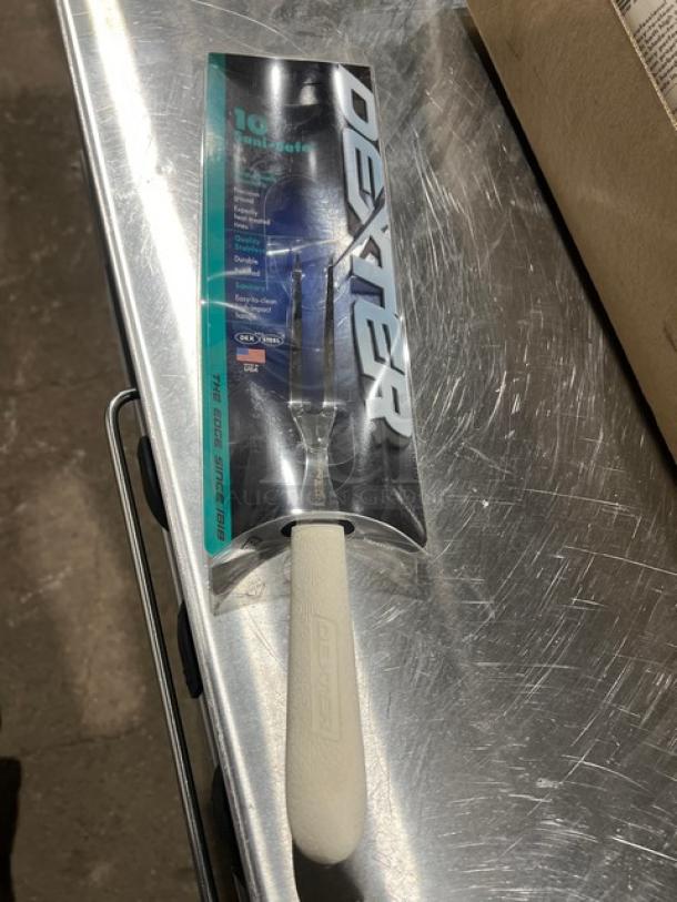 Dexter Sani Safe 10" Pot Fork, Model S203. New in packaging. Features a white handle and stainless steel tines.