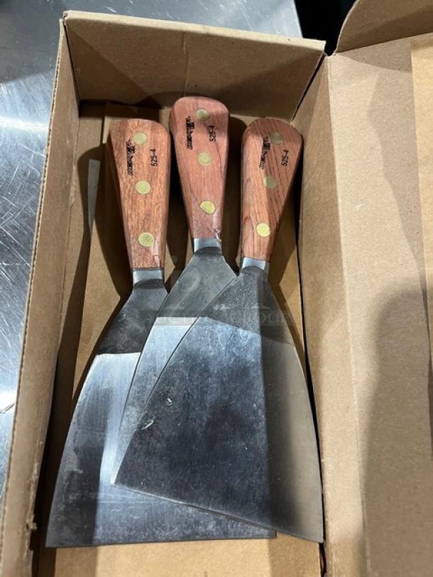 Dexter 4" stiff griddle scrapers, model 5254, with wooden handles in a box. Set of four, unused condition.