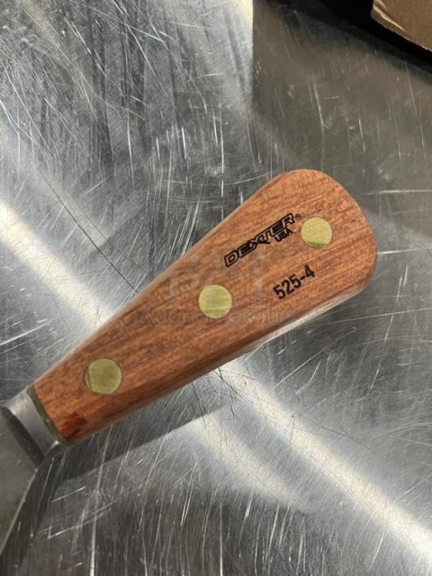Dexter 525-4 griddle scraper, wood handle with brass rivets, model S203, in excellent condition, visible branding.