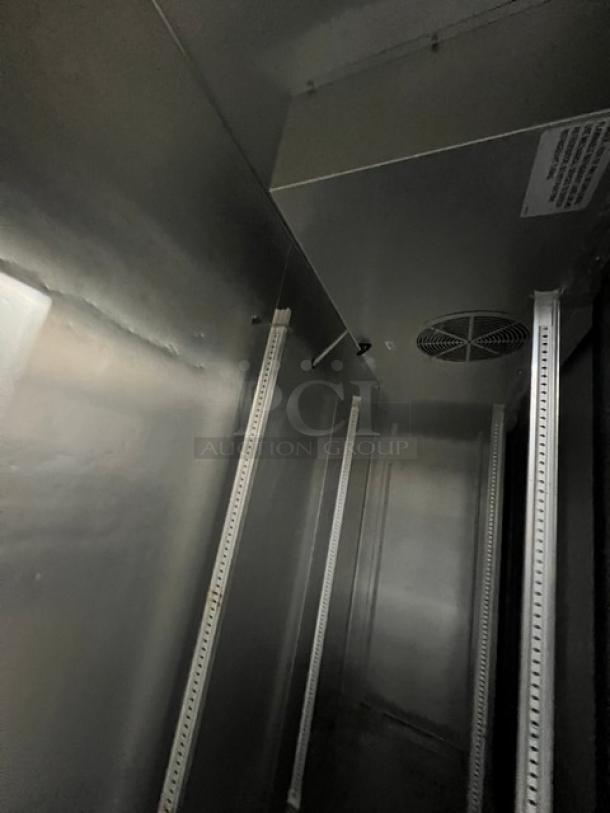 True T72HC commercial refrigerator interior, stainless steel finish, shelving tracks visible, model and serial tags not shown.