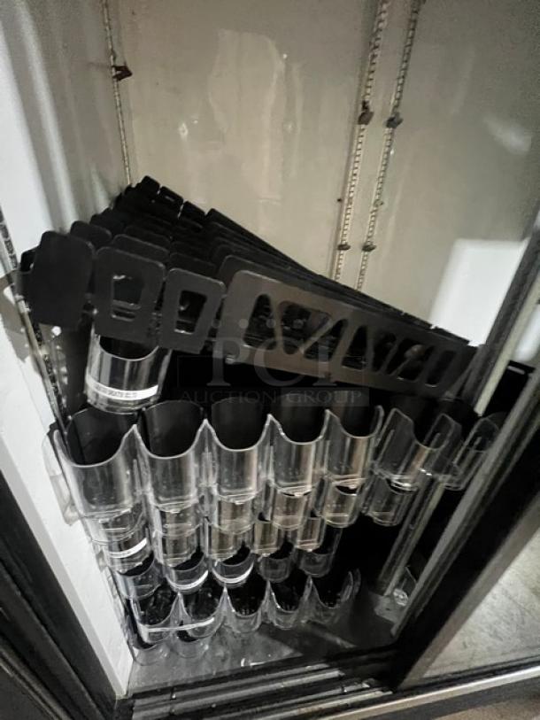 True GDM41 Commercial 2-Door Refrigerator Merchandiser with sliding view-through doors, black shelving, model labels displayed.