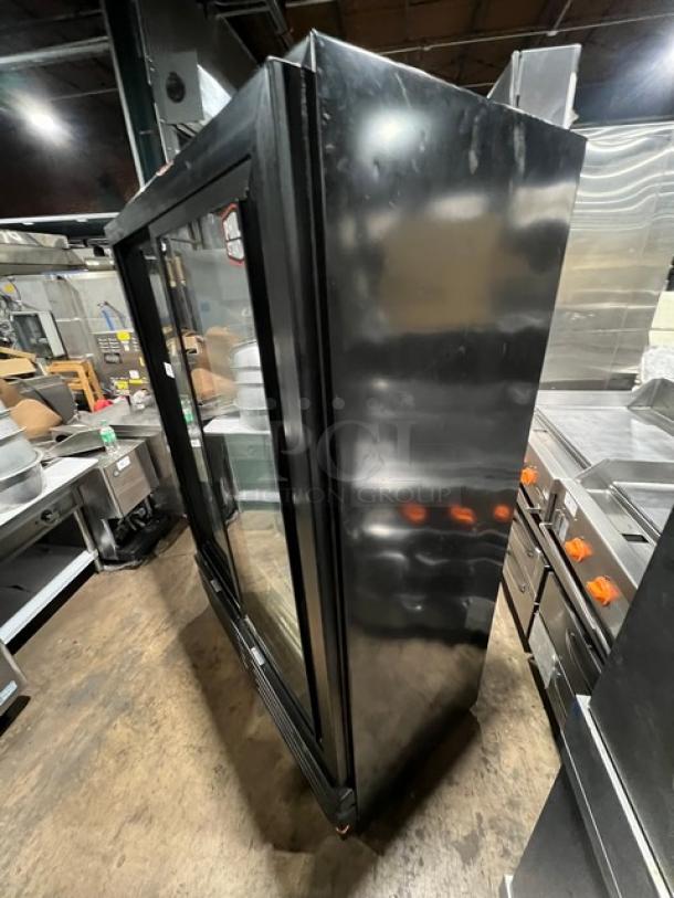 Imbera VRD43 commercial 2-door reach-in refrigerator, black finish, sliding view-through doors, model and serial numbers visible.