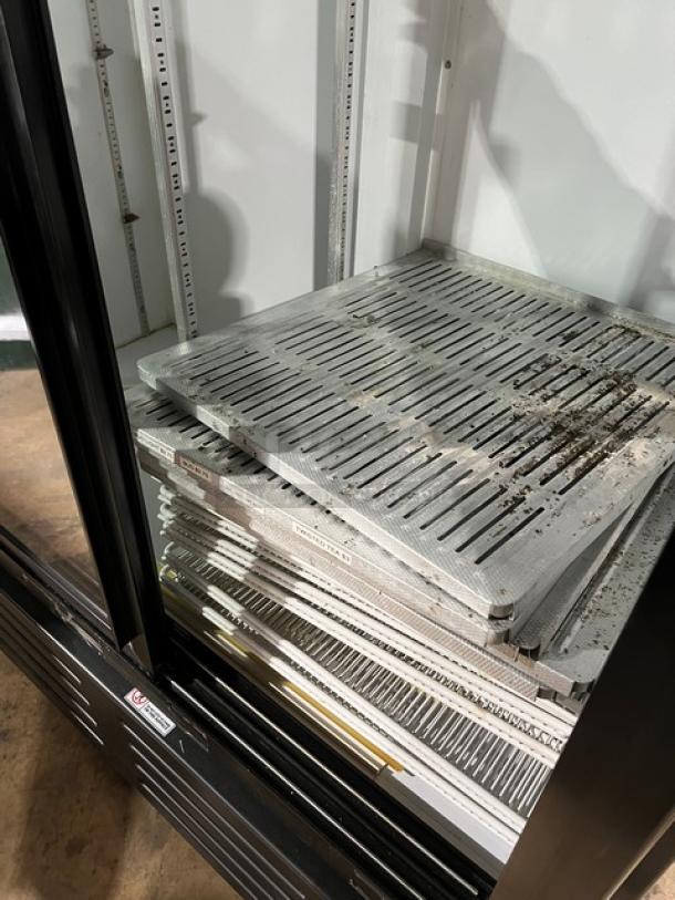 Imbera VRD43 commercial refrigerator with sliding view-through doors; visible interior shelving, model and serial labels.