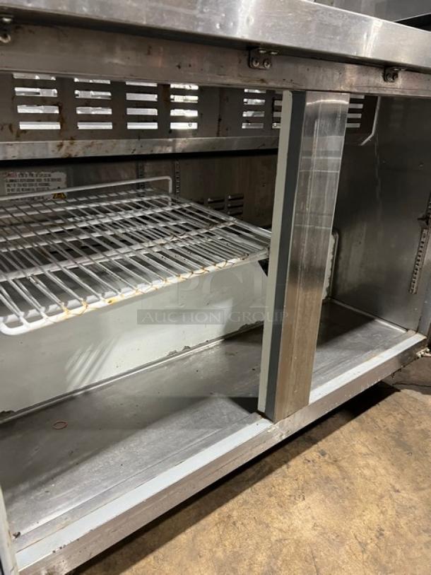 Avantco commercial refrigerated prep table, stainless steel, 2-door storage, 115V, visible shelves, used condition.