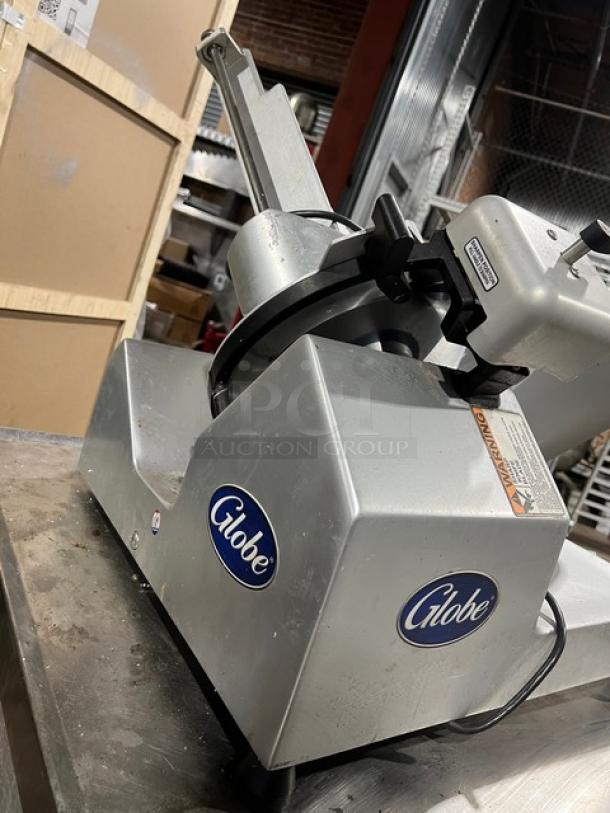 Globe S13 commercial deli meat slicer with 13" blade, all stainless steel, model S13-00-000161, 110V, in good condition.