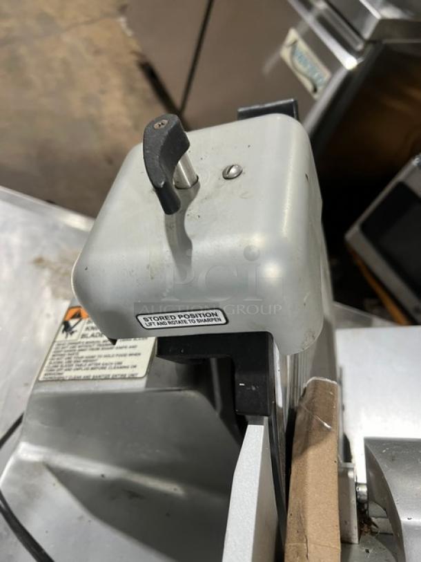 Globe S13 deli meat slicer with 13" blade, stainless steel, commercial countertop model; includes visible safety and storage labels.