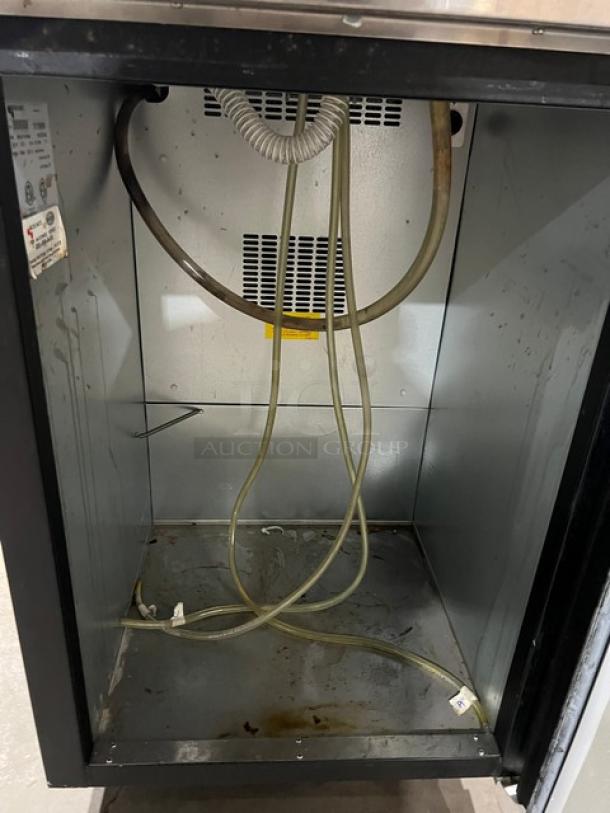 Micro Matic MDD-23 kegerator interior, showing cooling coils and wiring. Slight wear visible. Features stainless steel worktop.